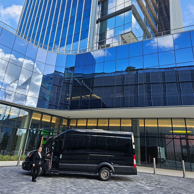 passenger-executive-transportation-vehicle-and-driver-parked-in-front-of-building